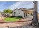 Backyard oasis with brick pathway and grassy area at 10802 W Almeria Rd, Avondale, AZ 85392