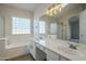 Bathroom with double sinks, a soaking tub, and a shower at 10802 W Almeria Rd, Avondale, AZ 85392