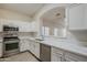 Modern kitchen with white cabinets and quartz countertops at 10802 W Almeria Rd, Avondale, AZ 85392