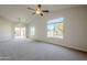 Living room with carpet flooring and access to a patio at 10802 W Almeria Rd, Avondale, AZ 85392