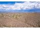 Wide aerial view of the property and surrounding mountain range at 12000 N 144Th Way, Scottsdale, AZ 85259