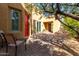 A red door and seating area are seen in this tranquil courtyard at 12000 N 144Th Way, Scottsdale, AZ 85259