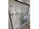 Updated shower with sliding glass doors and grab bar at 13626 W Aleppo Dr, Sun City West, AZ 85375