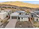 Modern house with desert landscaping, two-car garage, and mountain views at 14174 E Highland Ave, Fountain Hills, AZ 85268