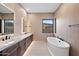 Spa-like bathroom with soaking tub, double vanity, and modern fixtures at 14174 E Highland Ave, Fountain Hills, AZ 85268