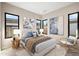 Cozy bedroom with comfortable bed, natural light, and accent chair at 14174 E Highland Ave, Fountain Hills, AZ 85268