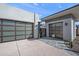Two-car garage with modern glass garage doors and paver driveway at 14174 E Highland Ave, Fountain Hills, AZ 85268