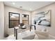 Modern home office with glass desk, comfortable seating, and large windows at 14174 E Highland Ave, Fountain Hills, AZ 85268