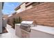 Luxury outdoor kitchen with stainless steel grill, built-in cabinetry, and granite countertops at 14174 E Highland Ave, Fountain Hills, AZ 85268