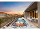 Long rectangular pool with fire pit and mountain views at 14174 E Highland Ave, Fountain Hills, AZ 85268