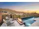 Relaxing poolside seating with fire pit and mountain views at sunset at 14174 E Highland Ave, Fountain Hills, AZ 85268