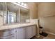 Bathroom boasts a vanity with tiled countertop and shower at 14950 W Mountain View Blvd # 1310, Surprise, AZ 85374