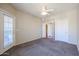 Well-lit bedroom featuring carpet, door to balcony and access to other rooms at 14950 W Mountain View Blvd # 1310, Surprise, AZ 85374