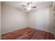 Hardwood floor bedroom with built-in shelving and ceiling fan at 14950 W Mountain View Blvd # 1310, Surprise, AZ 85374