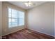 Well-lit bedroom with hardwood floors and large window at 14950 W Mountain View Blvd # 1310, Surprise, AZ 85374