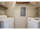 Well-lit laundry room with washer, dryer, and shelving at 14950 W Mountain View Blvd # 1310, Surprise, AZ 85374