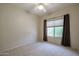 Bright bedroom with a window, ceiling fan, and brown curtains at 15805 W Arrowhead Dr, Surprise, AZ 85374