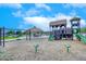 Community playground with play structures, swings, and a covered pavilion at 17316 W Seldon Ln, Waddell, AZ 85355