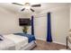 Cozy bedroom with a queen-size bed, TV, and blue accents at 1739 E Pleasant Ln, Phoenix, AZ 85042