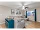 Living room with sectional sofa, ceiling fan and decorative wall art at 1739 E Pleasant Ln, Phoenix, AZ 85042