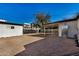 Spacious backyard with gravel and mature tree, providing ample outdoor space at 1818 E Monterey Way, Phoenix, AZ 85016