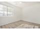 Well-lit bedroom with wood-look floors and a window with blinds at 1818 E Monterey Way, Phoenix, AZ 85016