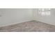 Bright bedroom featuring wood-look floors and a window with blinds at 1818 E Monterey Way, Phoenix, AZ 85016