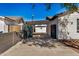 View of the home's gated side yard and driveway at 1818 E Monterey Way, Phoenix, AZ 85016