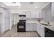 Modern kitchen with white cabinets, black appliances, and a patterned backsplash at 1818 E Monterey Way, Phoenix, AZ 85016