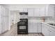Renovated kitchen featuring white cabinets and black appliances at 1818 E Monterey Way, Phoenix, AZ 85016