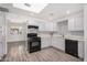 Updated kitchen boasts white cabinets, black appliances, and stylish backsplash at 1818 E Monterey Way, Phoenix, AZ 85016