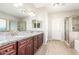 Double vanity bathroom with granite countertops and large mirrors at 30124 W Mckinley St, Buckeye, AZ 85396