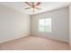 Bright bedroom with carpeted floor and ceiling fan at 30124 W Mckinley St, Buckeye, AZ 85396