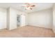Spacious bedroom with ceiling fan and access to bathroom at 30124 W Mckinley St, Buckeye, AZ 85396