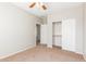 Bedroom with neutral walls, carpet, ceiling fan, and access to another room at 30124 W Mckinley St, Buckeye, AZ 85396