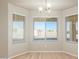 Bright dining room with large windows and wood flooring at 30124 W Mckinley St, Buckeye, AZ 85396