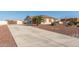 Long concrete driveway leading to a single-story home at 30124 W Mckinley St, Buckeye, AZ 85396