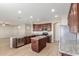 Modern kitchen with granite countertops and dark wood cabinetry at 30124 W Mckinley St, Buckeye, AZ 85396