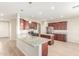 Open kitchen boasts granite counters and rich wood cabinets at 30124 W Mckinley St, Buckeye, AZ 85396