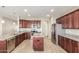 Kitchen with island, granite countertops, and stainless steel appliances at 30124 W Mckinley St, Buckeye, AZ 85396