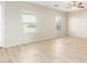 Spacious living area with large windows and wood-look floors at 30124 W Mckinley St, Buckeye, AZ 85396