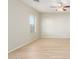 Bright living room with neutral walls, wood-look floors, and ceiling fan at 30124 W Mckinley St, Buckeye, AZ 85396