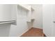 Bright walk-in closet with shelves and hanging rods at 30124 W Mckinley St, Buckeye, AZ 85396