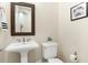 Elegant powder room with pedestal sink, toilet, and decorative mirror at 3291 E Cherrywood Pl, Chandler, AZ 85249
