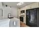 Modern kitchen with white cabinets, quartz countertops, and black appliances at 4808 N 24Th St # 531, Phoenix, AZ 85016