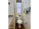 Bathroom with toilet, wood cabinets, and a linen closet at 7750 E Broadway Rd # 776, Mesa, AZ 85208