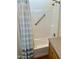 Bathroom with a tub shower, grab bar, and striped shower curtain at 7750 E Broadway Rd # 776, Mesa, AZ 85208