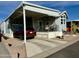 Exterior view of a manufactured home with carport and landscaping at 7750 E Broadway Rd # 776, Mesa, AZ 85208