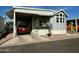 Exterior view of a manufactured home with carport and landscaping at 7750 E Broadway Rd # 776, Mesa, AZ 85208