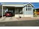 Inviting exterior of manufactured home with carport and landscaped front yard at 7750 E Broadway Rd # 776, Mesa, AZ 85208